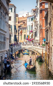 Venice, Italy, 07.04.2019 view of narrow Venetian Canal with gondolier riding gondola