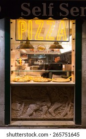 VENICE, ITALY - 14TH MARCH 2015: The Outside Of A Takeaway Pizza Shop In Venice At Night