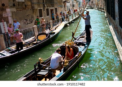 Venice, Italy - 20 , 2019: real marriage proposal on a gondola. romantic couple promising love and showing ring in venetian channel on a sunny summer day. candid moment