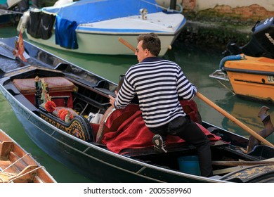 Venice, Italy, Europe - May, 8th, 2021 -  Boat Ride By Typical Gondola