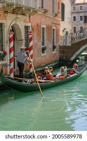 Venice, Italy, Europe - May, 8th, 2021 -  Boat Ride By Typical Gondola