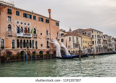 VENICE, ITALY - JANUARY 04, 2018: Venice Monumental Gigantic hands rise from Grand Canal to support Sagredo Hotel.
