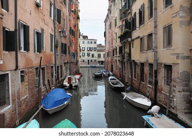 Venice, Italy. Traditional Narrow Canal Street With Fish Boats And Old Houses.