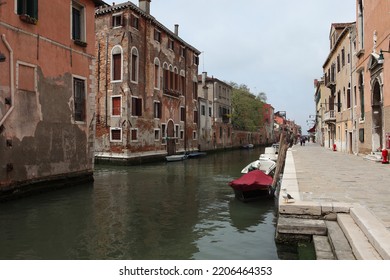 Venice, Italy. Traditional Narrow Canal Street With Fish Boats And Old Houses.