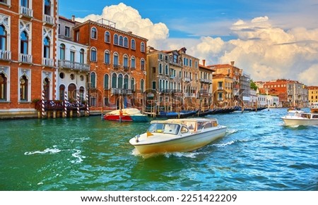 Venice, Italy. Veneto region. Motorboats moving by Grand Canal. Picturesque landscape with romantic italian architecture. Brick venetian houses, street along water channel. Transport in Venezia
