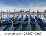 Venice Lagoon in Italy, Gondolas traditional Venetian boats at Riva degli Schiavoni and San Giorgio Maggiore island on the horizon.