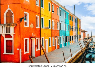 Venice landmark, Burano island canal, colorful houses and boats.