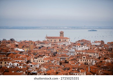 Venice under a gray sky. Dramatic and melancholic perspective of the canals and gondolas in Italy.