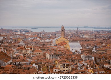 Venice under a gray sky. Dramatic and melancholic perspective of the canals and gondolas in Italy.