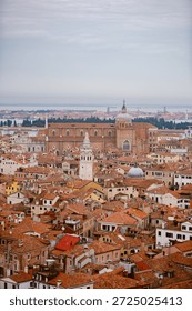 Venice under a gray sky. Dramatic and melancholic perspective of the canals and gondolas in Italy.