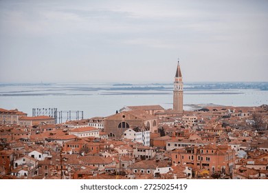Venice under a gray sky. Dramatic and melancholic perspective of the canals and gondolas in Italy.