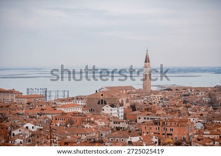Venice under a gray sky. Dramatic and melancholic perspective of the canals and gondolas in Italy.