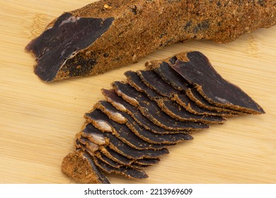 Venison Jerky Sliced And Spicy Dry-cured Full Piece On Wooden Table. Dried Deer Meat Snacks For Beer. Top View