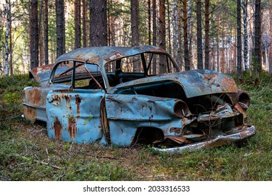 Venjan, Sweden, 2021-05-13. Old And Beat Up Retro Car, Abandoned In A Forest.