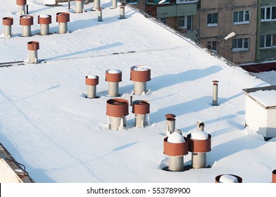 Vent Pipes On The Roof. The Flat Roof Is Completely Covered With Snow.