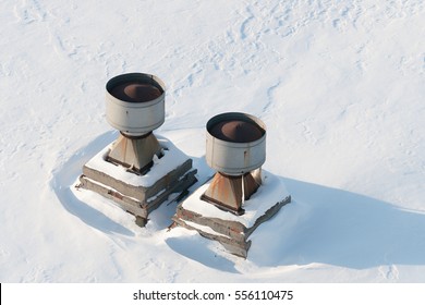 Vent Pipes On The Roof. The Flat Roof Is Completely Covered With Snow.