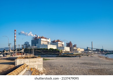 Ventanas, Chile; 2021-11-16: Coal-fired thermoelectric plant next to the beach with a port behind