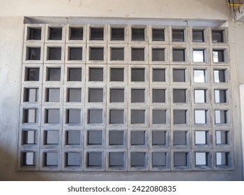 Ventilated block panel with safety net installed on a concrete wall.      