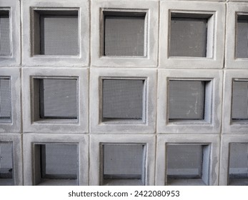 Ventilated block panel with safety net installed on a concrete wall.       