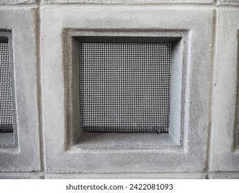 Ventilated block panel with safety net installed on a concrete wall. 
