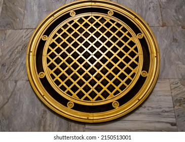 The ventilation grille is bronze with several circles and squares in the center. Architecture technology construction.
