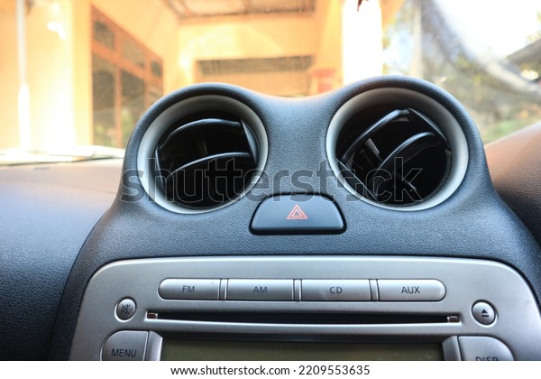 ventilation\
grilles in the car close-up, car air conditioner heating, faulty\
air conditioner concept, bad smell in the car, refilling\
refrigerant in the car air\
conditioner