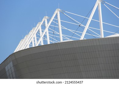 Ventilation panel on facade of building. rainscreen. exterior wall. white perforated panels. Metallic modern design. Supports on roof. blue sky background. Modern abstract facade design. Geometric