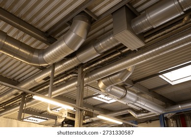 Ventilation pipes along the ceiling inside a building, part of the HVAC system and indoor infrastructure.