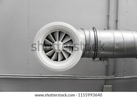 Ventilation system on the ceiling of large buildings. Ventilation pipes in silver insulation material hanging from the ceiling inside new building.