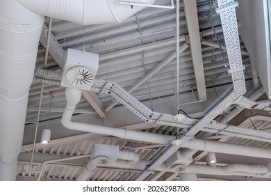 Ventilation system under ceiling of modern warehouse or shopping center. Metal piping for air conditioning