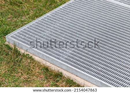 Ventilation Vent Exit of Modern Underground Parking. Garvanized Surface Manhole Ventilation on Ground  grass.