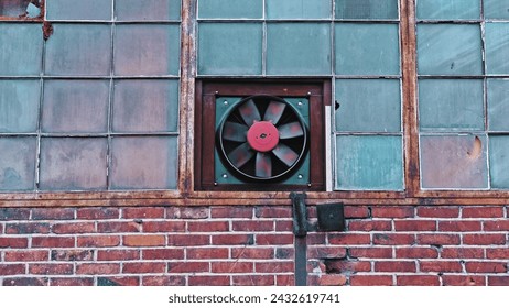 Ventilator Fan Mounted in Red Brick Industrial Factory Buildling Window