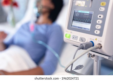 Ventilator monitor and african american female patient in hospital bed with oxygen ventilator. medicine, health and healthcare services during coronavirus covid 19 pandemic.
