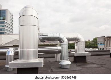 ventilators on the roof of a tall building in the industrial area
