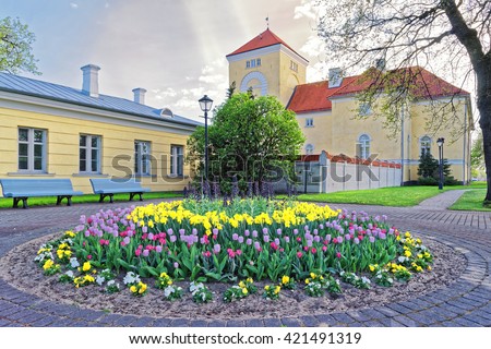 Ventspils Castle and tulips in the flowerbed in the Old toen in Latvia. The Castle was built by the Livonian Order. It is the oldest castle built by the Livonian Order.