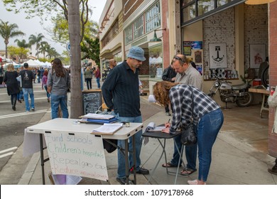 Ventura, CA: March 31, 2018: A Signature Gatherer For Upcoming Ballot Initiatives In The State Of California. In California, Voters Vote On Proposed Laws Via Ballot Propositions.