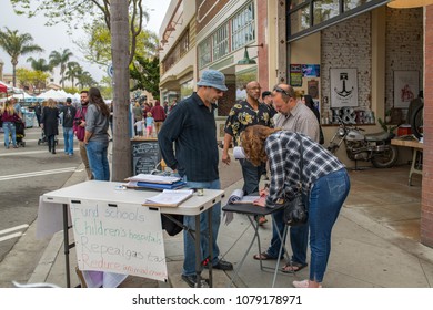 Ventura, CA: March 31, 2018: A Signature Gatherer For Upcoming Ballot Initiatives In The State Of California. In California, Voters Vote On Proposed Laws Via Ballot Propositions.