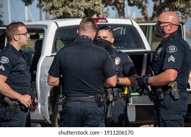 Ventura, California, United States -  August 7, 2020: Diverse Police Officers From The City Of Ventura Police Department Have A Discussion During A Search Of A Suspect's Vehicle At Ventura Harbor. 