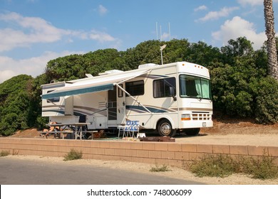 VENTURA COUNTY, CALIFORNIA, UNITED STATES - OCTOBER 06, 2006. A Man And His Dog Enjoying The Shade Of Their Trailer On A Beautiful Sunny Day In The Parking Lot For RVs In Faria Beach National Park.