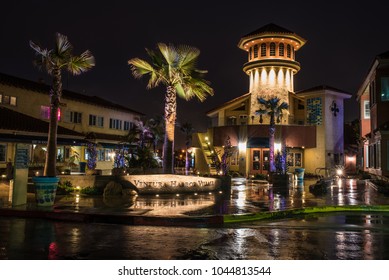 Ventura Harbor Village in California, United states wet and reflecting morning spot lights of shopping area in the predawn hours of March, 2018.