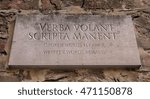 Verba volant scripta manent. Latin phrase meaning Spoken words fly away, written words remain. Engraved text.
