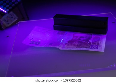 Verifying The Authenticity Of The Fifty Hryvnia Banknote In Ultraviolet Light. Ukrainian Money. Mykhailo Hrushevsky. Equipment For In-depth Inspection Of Money. Fake Money Or Financial Crisis Concept