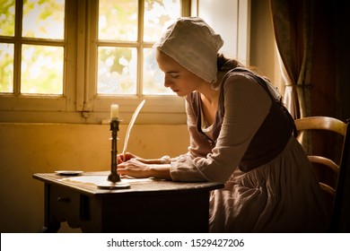 Vermeer style portrait of a young maid in renaissance costume writing a letter with a feather quill