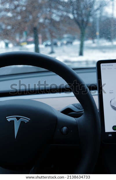 VERMONT, UNITED STATES-\
MARCH 9, 2022: Soft focus of Interior dashboard design and steering\
wheel decoration of \'TESLA MODEL 3\' electric-powered performance\
car