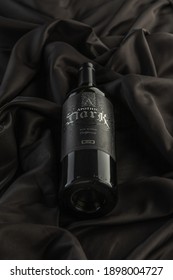 Vero Beach, Florida; USA; Dec. 7, 2020. A Close Up And Detailed Top Down View Of A Bottle Of Apothic Dark Red Wine. The Wine Bottle Is Photographed On A Wrinkled Silk Cloth Material Surface. 