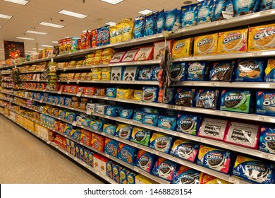 Vero Beach, FL/USA - 8/2/19 - The Cookie Aisle In A Grocery Store With Two People Shopping.