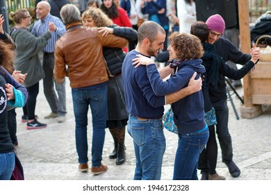 Verona, Italy - 02 15 2016: People Dancing At A Village Festival.
A Young Couple Smiles As They Dance A Mazurka.
Popular Dances And Folk Festivals In Winter Time.             