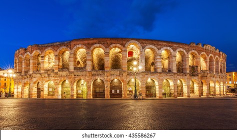 Verona, Italy. Ancient amphitheater Arena di Verona in Italy like Rome Coliseum with nighttime illumination and evening blue sky. Verona's italian famous ancient landmark theatre. Veneto region.