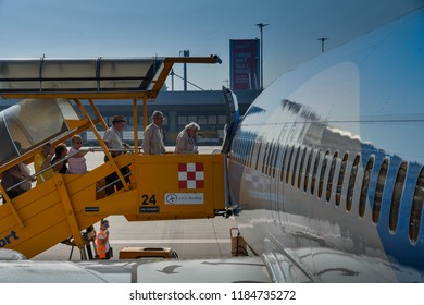 VERONA, ITALY - SEPTEMBER 2018: Passengers Boarding Through The Front Door Of A TUI Boeing 737 At Verona Airport.