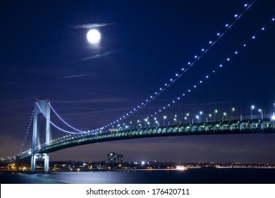 Verrazano Narrows Bridge with full moon in New York City at evening. It connects Brooklyn with Staten Island.